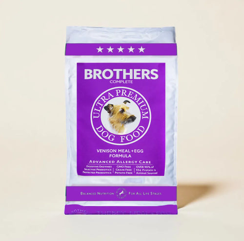 Purple bag of Brothers Complete Ultra Premium Dog Food on a beige background